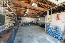 Garage featuring concrete block wall and a garage door opener - 