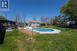 View of swimming pool with a sunroom and a patio - 