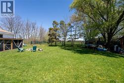 Fenced backyard featuring a trampoline - 