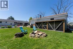 View of outdoor structure with a sunroom and an outdoor fire pit - 