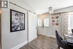 Office with french doors, wood finished floors, and a barn door - 