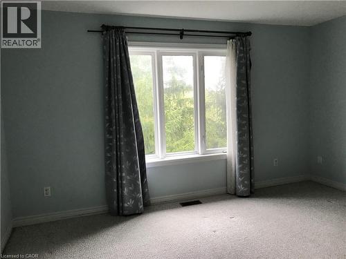 Unfurnished room featuring carpet and baseboards - 4294 Ingram Common, Burlington, ON - Indoor