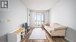 Sitting room featuring expansive windows, a textured ceiling, and dark wood-type flooring - 
