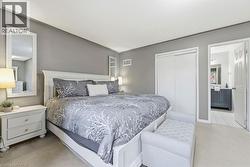 Bedroom with carpet, a closet, and ensuite bath - 
