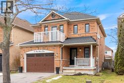 View of front of property featuring a shingled roof, a porch, driveway, and a front lawn - 