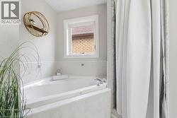 Bathroom with a bath and a shower with shower curtain - 