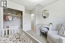 Carpeted bedroom with attic access, a crib, a closet, and a textured ceiling - 