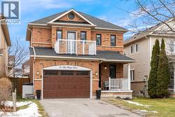 View of front of home with roof with shingles, a balcony, a porch, and driveway - 