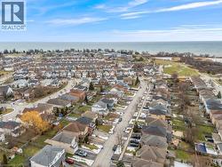 Aerial view of property and surrounding area featuring nearby suburban area and a large body of water - 