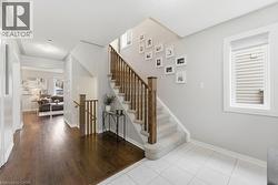 Stairway featuring hardwood / wood-style flooring and baseboards - 