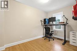 Office space with baseboards and light wood-style flooring - 