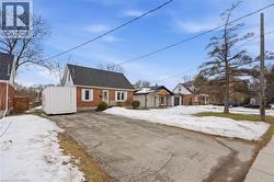 View of front facade featuring brick siding and a shingled roof - 
