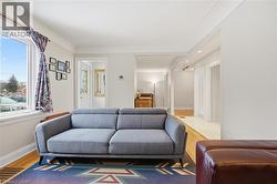 Living area with baseboards and wood finished floors - 