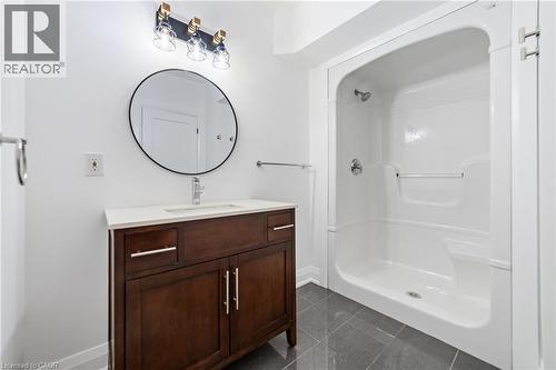 Basement bathroom features walk-in shower with grab bar and seat, stand alone vanity and toilet - 515 Hamilton Drive, Ancaster, ON - Indoor Photo Showing Bathroom