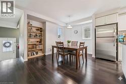 Dining space with dark wood-type flooring and built in features - 