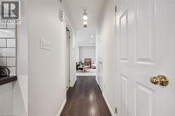 Corridor with dark wood finished floors and baseboards - 