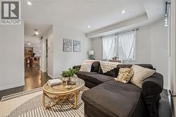 Living area featuring dark wood-style flooring and recessed lighting - 