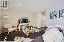 Living area with wood finished floors and recessed lighting - 