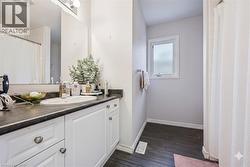 Bathroom featuring curtained shower and vanity - 