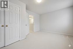 Unfurnished bedroom with carpet, a chandelier, and a textured ceiling - 