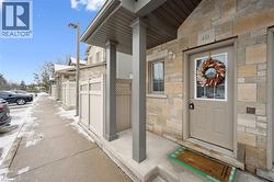 View of exterior entry with stone siding and a gate - 
