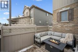 View of patio with an outdoor living space with a fire pit - 