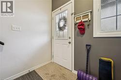 Doorway to outside featuring baseboards - 