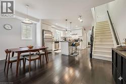 Dining room featuring stairs, dark wood-style floors, and recessed lighting - 