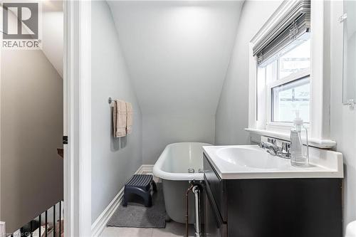 Full bathroom with a soaking tub, vanity, and lofted ceiling - 140 Royal Avenue, Hamilton, ON - Indoor Photo Showing Bathroom