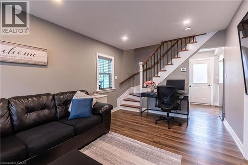 Living room with stairs, wood finished floors, and a desk - 140 Royal Avenue, Hamilton, ON - Indoor Photo Showing Other Room