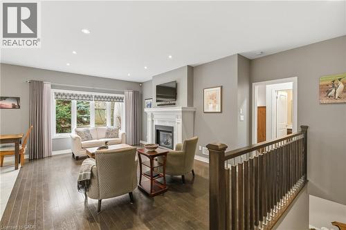Custom spindles/fireplace, hardwood floors - 21 Tulip Tree Road, Niagara-On-The-Lake, ON - Indoor With Fireplace