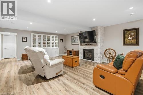Stunning Lower level, lux vinyl flrs - 21 Tulip Tree Road, Niagara-On-The-Lake, ON - Indoor Photo Showing Living Room With Fireplace