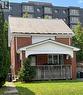 Contemporary home featuring a front lawn, brick siding, covered porch, and a metal roof - 179 Regina Street N, Waterloo, ON  - Outdoor 