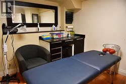 Home office featuring wood finished floors and baseboards - 