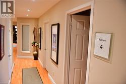 Hallway featuring light wood-style floors and recessed lighting - 