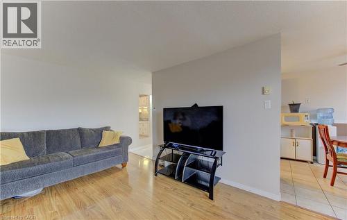 Living room featuring light wood-style flooring and baseboards - 4 Avalon Place Unit# 103, Kitchener, ON - Indoor Photo Showing Living Room
