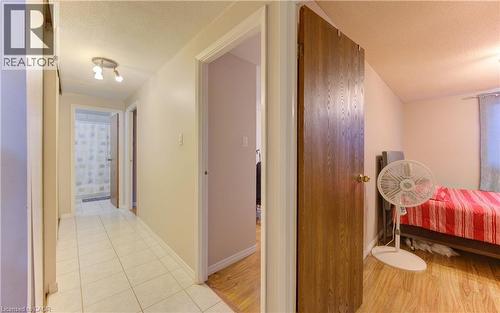 Hall featuring a textured ceiling and light wood-type flooring - 4 Avalon Place Unit# 103, Kitchener, ON - Indoor