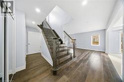 Staircase featuring wood finished floors and recessed lighting - 