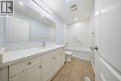 Full bathroom featuring vanity, light tile patterned floors, and shower / bath combination - 