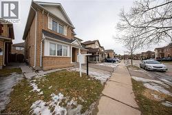 View of side of property with a residential view and brick siding - 