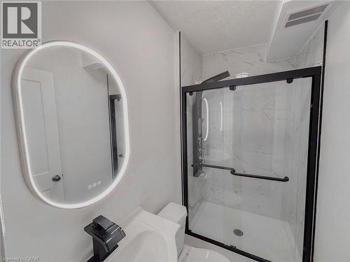 Full bath with a marble finish shower, a textured ceiling, and vanity - 1949 Old Mill Road, Kitchener, ON - Indoor Photo Showing Bathroom