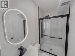 Full bath with a marble finish shower, a textured ceiling, and vanity - 