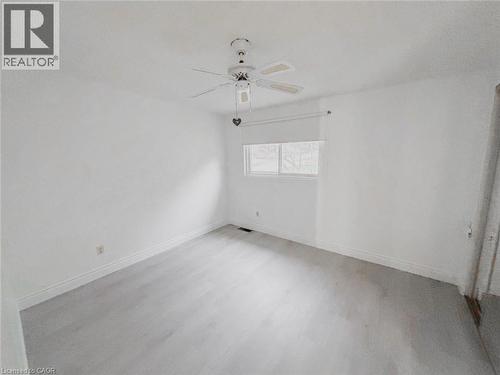 Empty room with wood finished floors and ceiling fan - 1949 Old Mill Road, Kitchener, ON - Indoor
