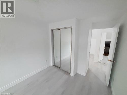 Unfurnished bedroom with a closet and light wood-style flooring - 1949 Old Mill Road, Kitchener, ON - Indoor Photo Showing Other Room