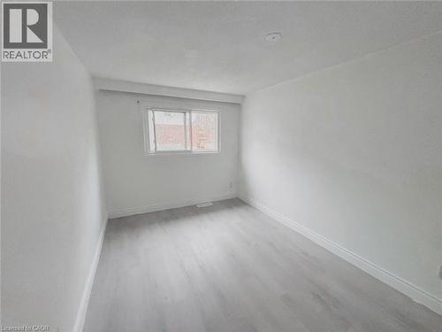 Unfurnished room featuring baseboards and light wood-style floors - 1949 Old Mill Road, Kitchener, ON - Indoor Photo Showing Other Room
