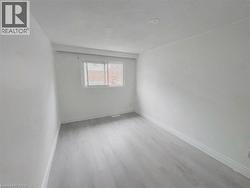 Unfurnished room featuring baseboards and light wood-style floors - 