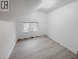 Additional living space with lofted ceiling and light wood-style flooring - 