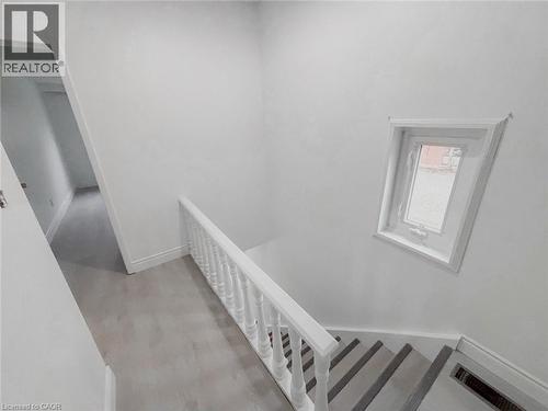 Stairway with baseboards and wood finished floors - 1949 Old Mill Road, Kitchener, ON - Indoor Photo Showing Other Room