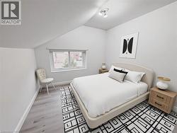 Bedroom featuring lofted ceiling and light wood-type flooring - 