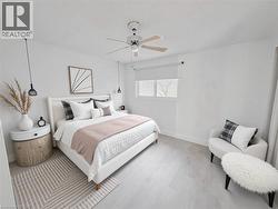 Bedroom featuring ceiling fan and baseboards - 